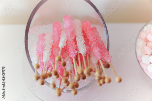 Pink and white sugar stick in clear bowl