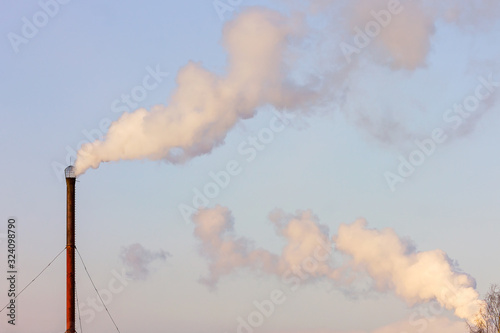 Fotografie View of smoke from the pipes of old stoker on a background of blue sky