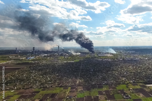 major fire at the factory. dark puffs of smoke from buildings.
