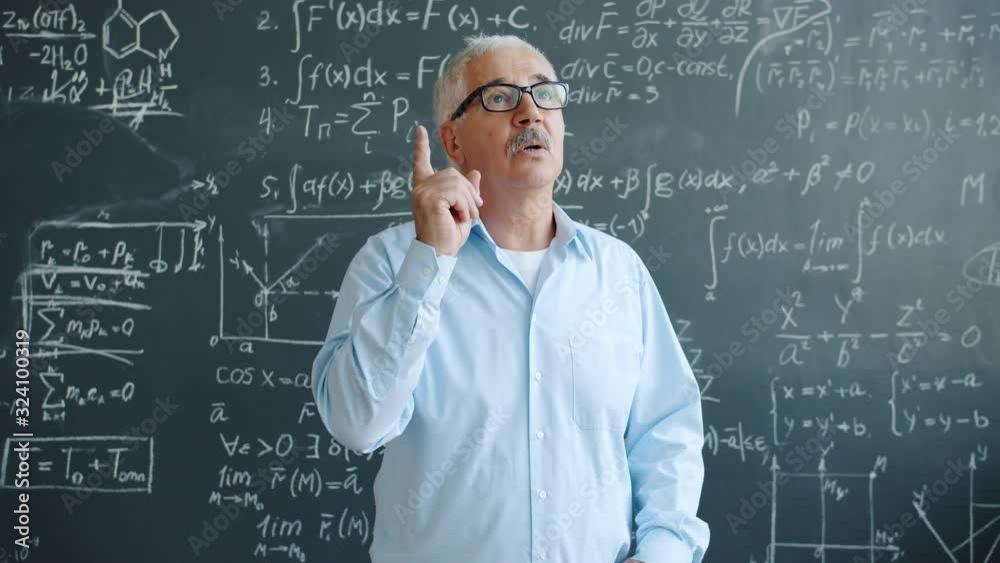 Creative scientist in glasses is raising finger having good idea working with chalkboard in class thinking about scientific problem finding solution. People and science concept. Creative scientist in glasses is raising finger having good idea working with chalkboard in class thinking about scientific problem finding solution. People and science concept.