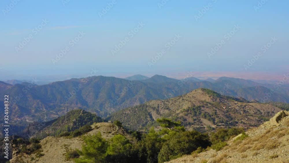 aerial drone shot above Troodos mountains in Cyprus, camera tilts up to reveal distant mountain range aerial drone shot above Troodos mountains in Cyprus, camera tilts up to reveal distant mountain range
