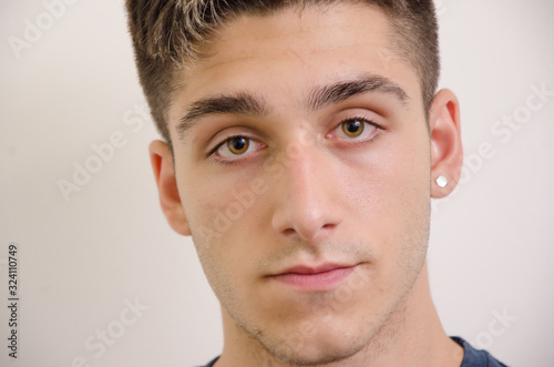 Young male Caucasian looking straight at the camera