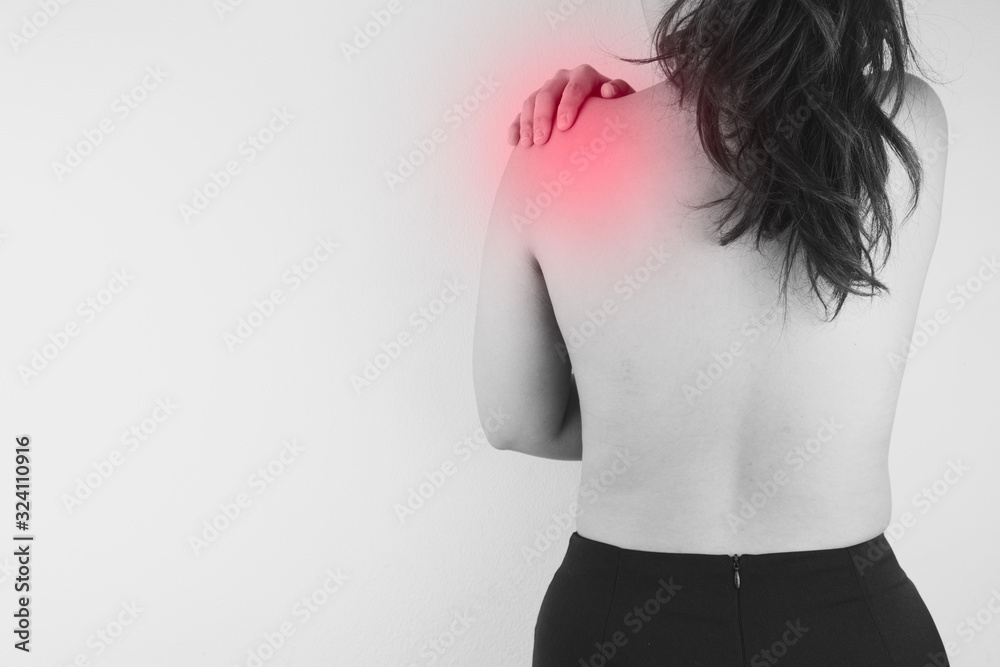 Black and white closeup woman suffering from neck and shoulder pain with red spot. Health care and medical concept. Black and white closeup woman suffering from neck and shoulder pain with red spot. Health care and medical concept.