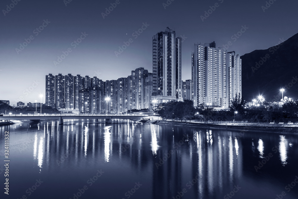 Naklejka premium High rise residential building and mountain in Hong Kong city at dusk