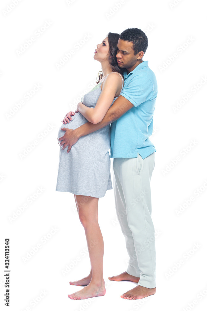Naklejka premium A young black man helps his white wife with birth pain with a ball. Partnered birth, partnered delivery. Isolated white background.