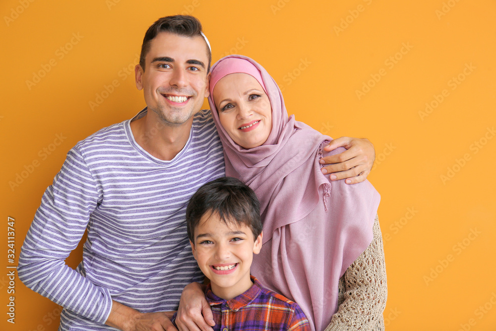 Fototapeta premium Portrait of Muslim family on color background