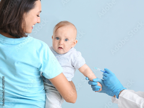 Pediatrician vaccinating li...