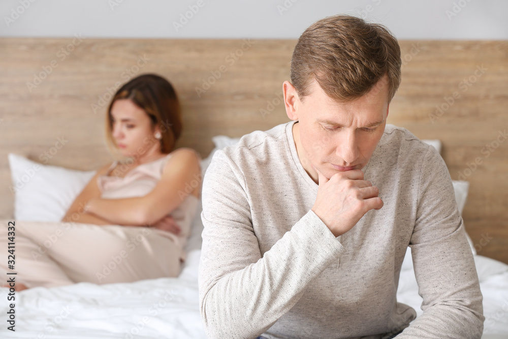 Sad couple after quarrel in bedroom Sad couple after quarrel in bedroom