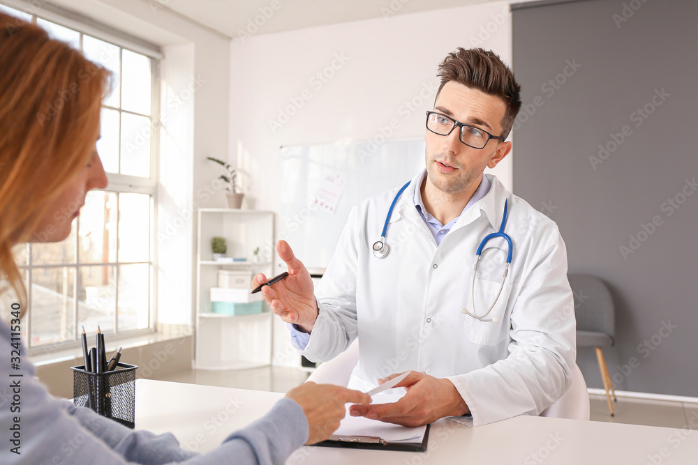 Mature woman visiting male cardiologist in clinic Mature woman visiting male cardiologist in clinic
