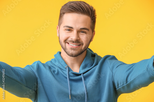 Young man taking selfie on ...