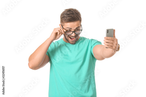 Young man taking selfie on ...