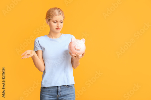 Sad woman with piggy bank o...