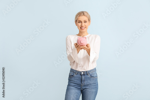 Young woman with piggy bank...