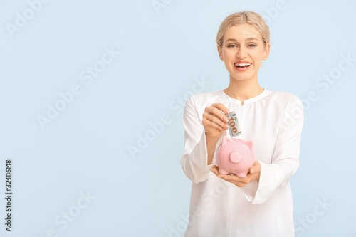 Young woman with piggy bank...