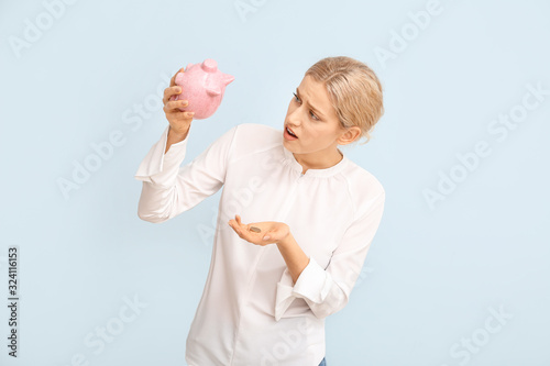 Sad woman with empty piggy ...