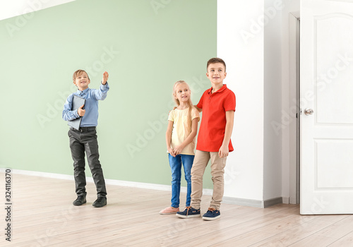 Little real estate agent showing clients a new house