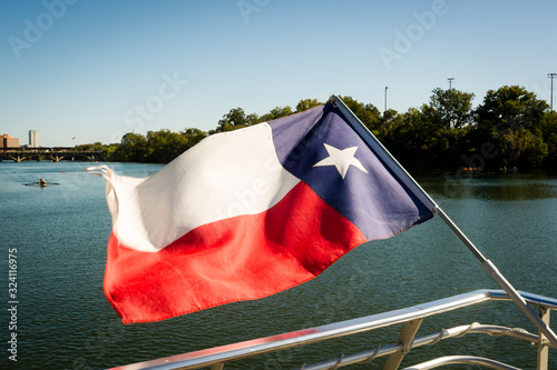 Texas flag flying from transom of boat on Ladybird Lake in Austin Texas