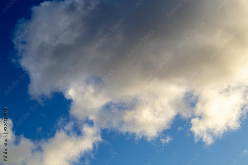 Bright white with grey clouds on blue sky. Beautiful background.