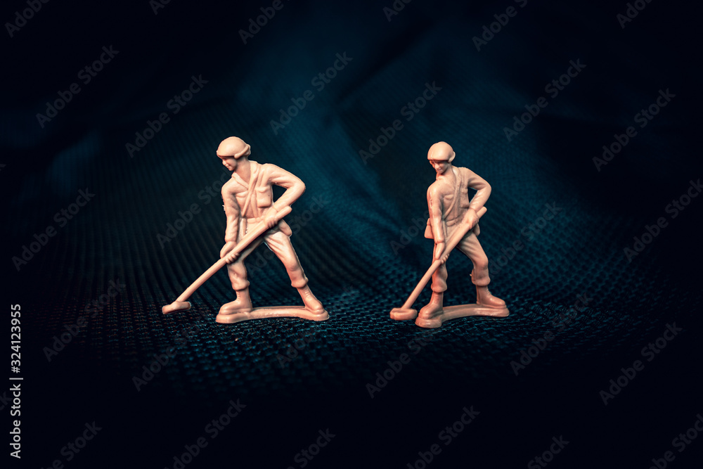 Tan plastic army man with mine sweeper