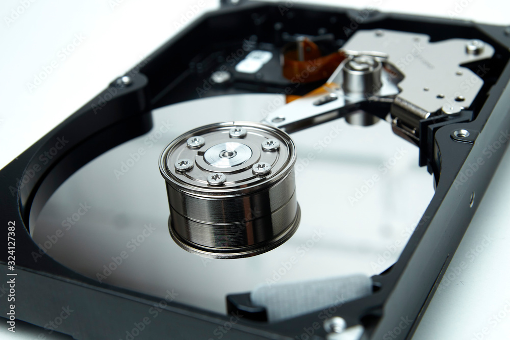 Opened hard drive from the computer hdd disk drive with mirror effects. Disassembled hard drive from the computer Opened hard drive from the computer hdd disk drive with mirror effects. Disassembled hard drive from the computer