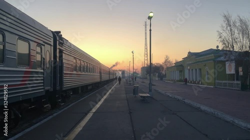 Train Waiting At Dzun-Khara Railway Station At Sunset. Trans-Mongolian Express. photo