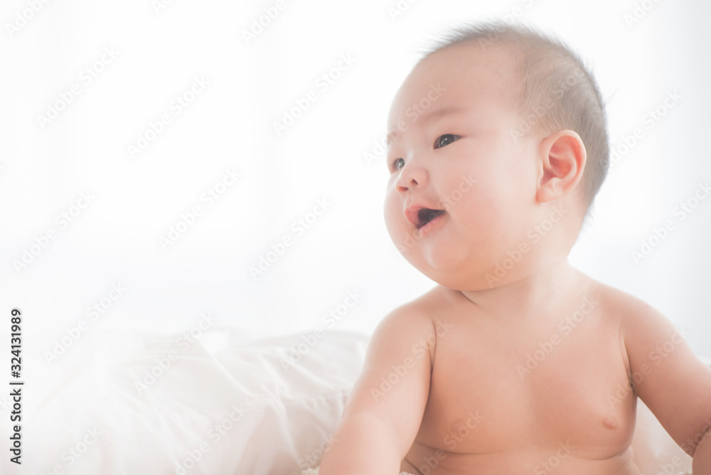 newborn child relaxing in bed. adorable baby boy in white sunny bedroom. nursery for young children. textile and bedding for kids. family morning at home. six month. childhood and baby care concept. newborn child relaxing in bed. adorable baby boy in white sunny bedroom. nursery for young children. textile and bedding for kids. family morning at home. six month. childhood and baby care concept.