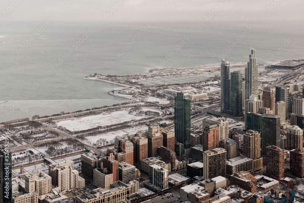 High angle view of Chicago downtown panorama in winter, frozen lake with snow on Lake Michigan