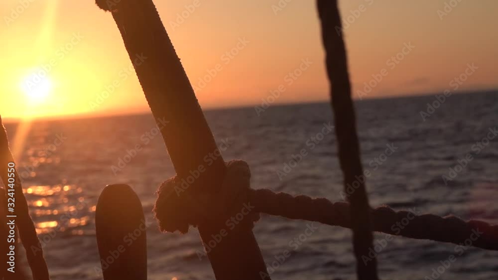 Sunset through the shrouds and rigging of an old sailing vessel. Sunset through the shrouds and rigging of an old sailing vessel.