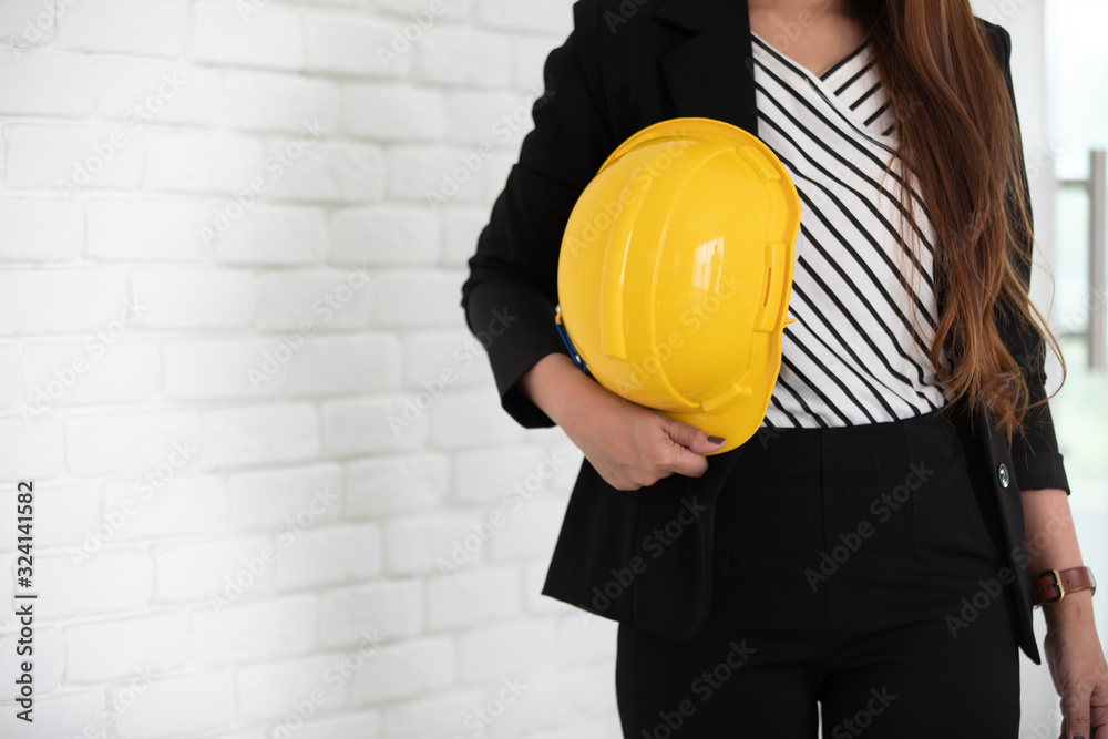 Business people in office with hard hat, safety first concept. Business people in office with hard hat, safety first concept.