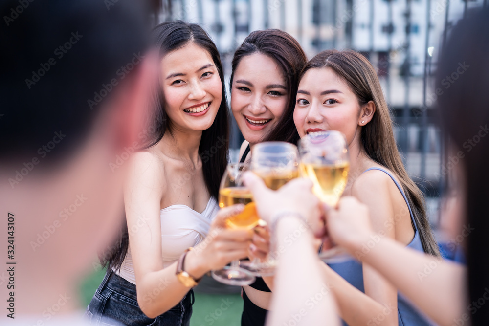 Group of young cute Asian girl gang best friends having party at rooftop restaurant. Girls drinking beer alcohol and toasting glass feeling happy enjoy, fun with smile face. Night lifestyle concept. Group of young cute Asian girl gang best friends having party at rooftop restaurant. Girls drinking beer alcohol and toasting glass feeling happy enjoy, fun with smile face. Night lifestyle concept.