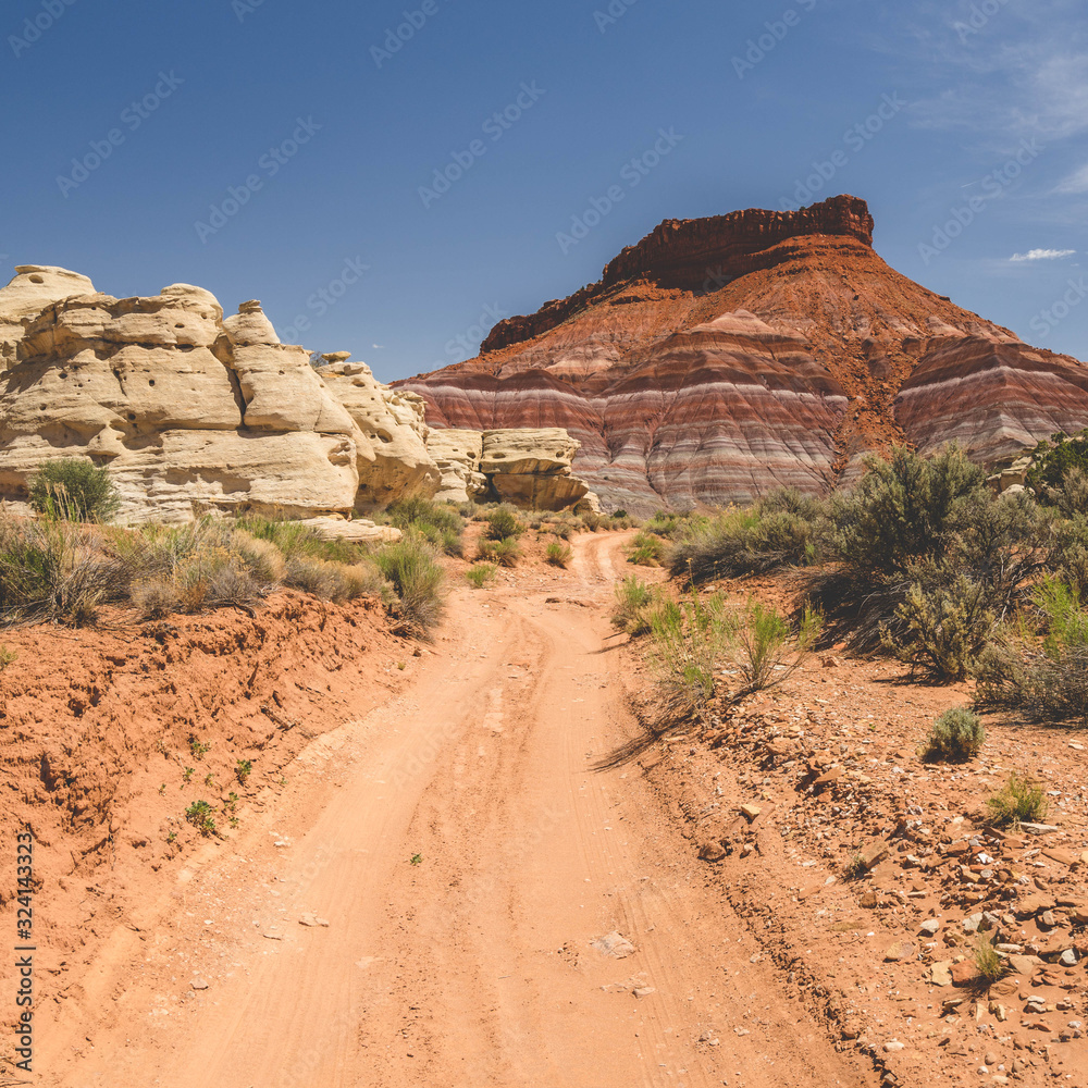 Fototapeta premium Dirt Road Leading to Colorful Cliffs