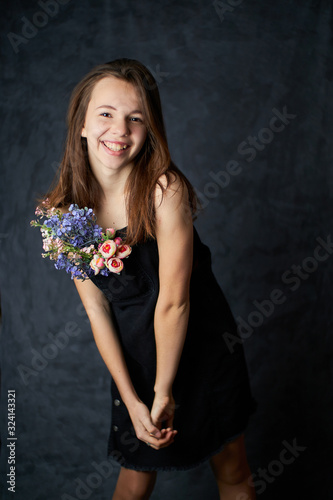 girl with flowers on a black background