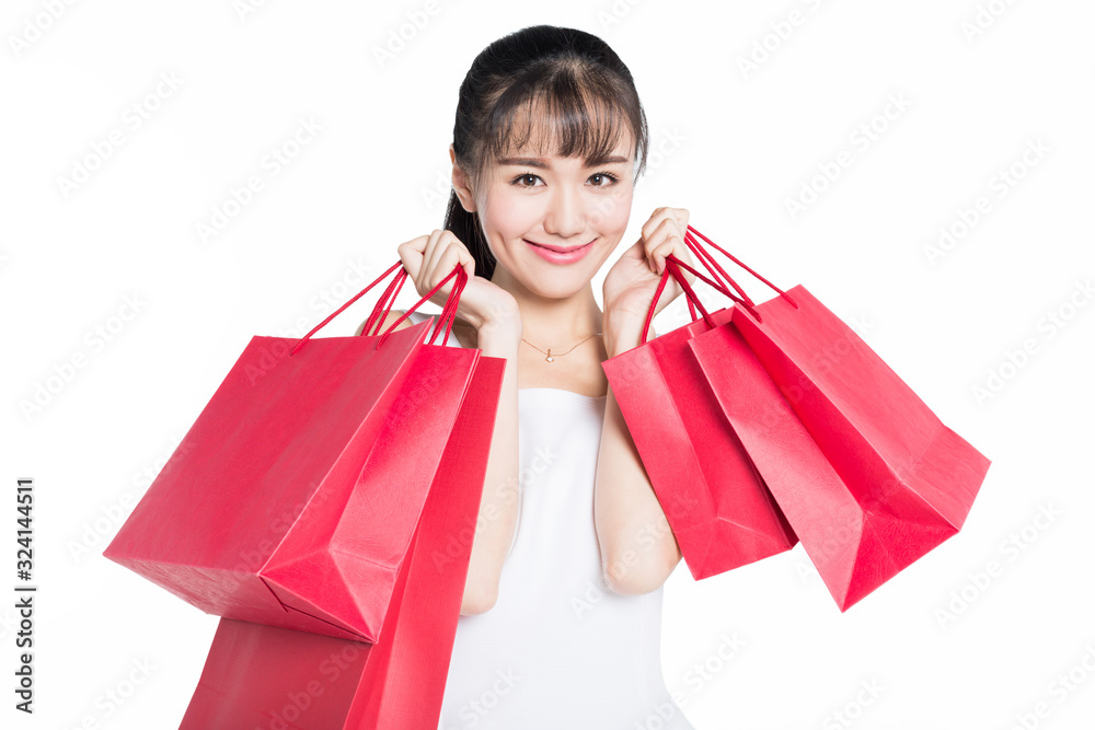 cheerful woman carrying red shopping bags on white background. cheerful woman carrying red shopping bags on white background.