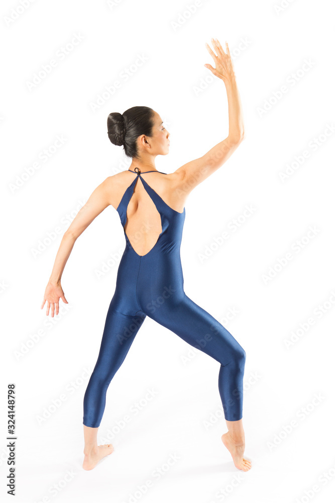 Adult woman dancer in blue bodysuit dancing in the studio. Adult woman dancer in blue bodysuit dancing in the studio.