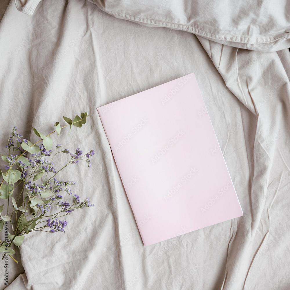 Pink diary and flowers on the bed, flat, top view