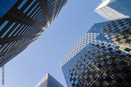Bottom view of modern office buildings in financial district at sunset  real estate and success concept  USA