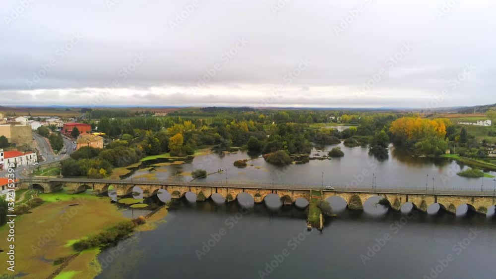 Alba de Tormes, Pan left aerial shot over river Tormes on a beautiful day. Alba de Tormes, Pan left aerial shot over river Tormes on a beautiful day.