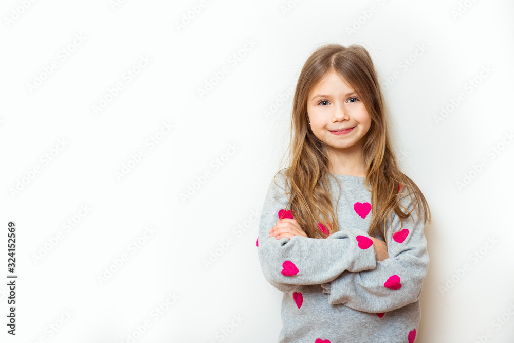 Positive child girl on a white background. Love symbol concept Positive child girl on a white background. Love symbol concept