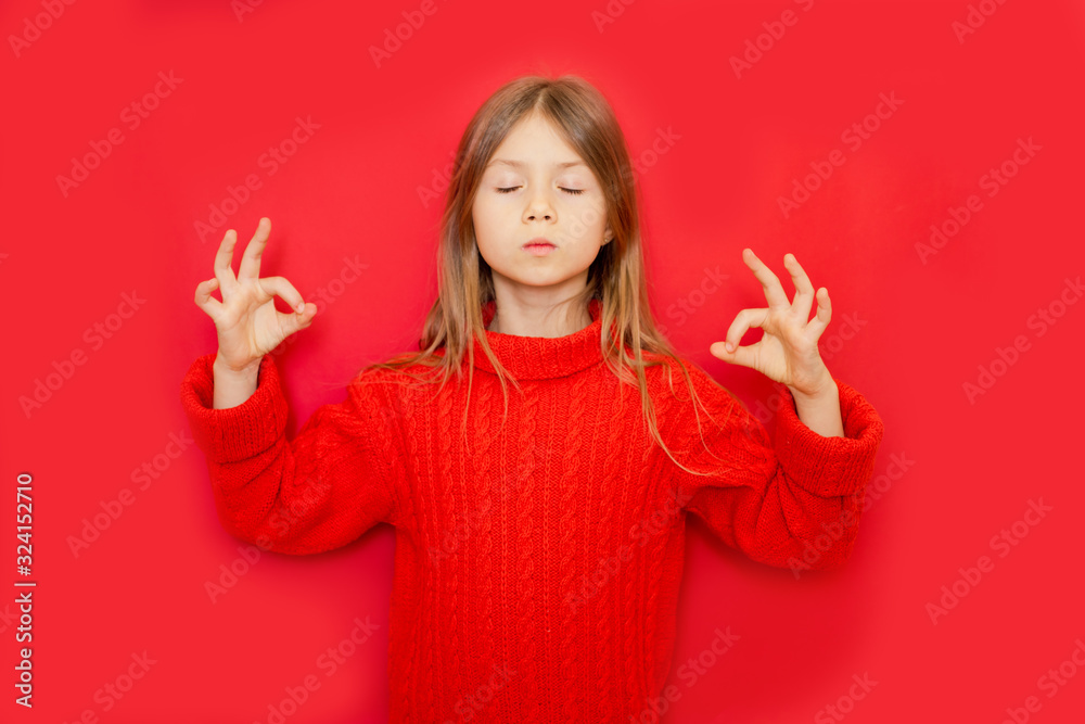 Young child girl standing over red isolated background relaxed and smiling with eyes closed doing meditation gesture with fingers. Yoga concept Young child girl standing over red isolated background relaxed and smiling with eyes closed doing meditation gesture with fingers. Yoga concept