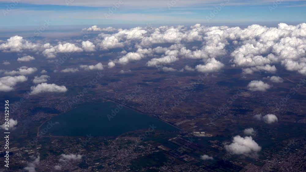 Airplane Window View - flying over mountains near Mexico City with scattered clouds. Airplane Window View - flying over mountains near Mexico City with scattered clouds.