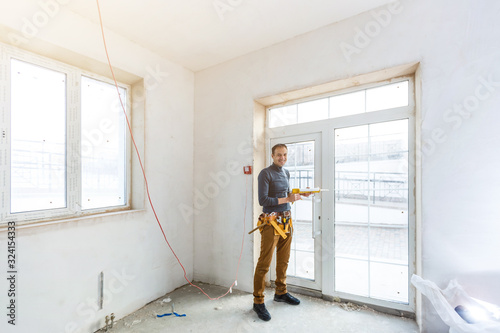 Wallpaper Mural Construction worker installing window in house Torontodigital.ca