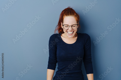 Cute young woman giggling to herself