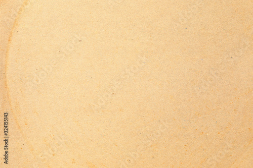 Brown kraft paper background texture with grain and dots 