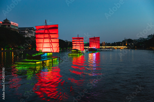 Tourist boats crusing the waters of Two Rivers and Four Lakes scenic spot in Guilin, China photo