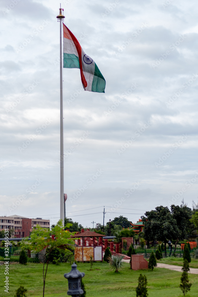 Indian tricolor flag hoisted on a cloudy morning with beautiful sky in the background. Patriotism concept