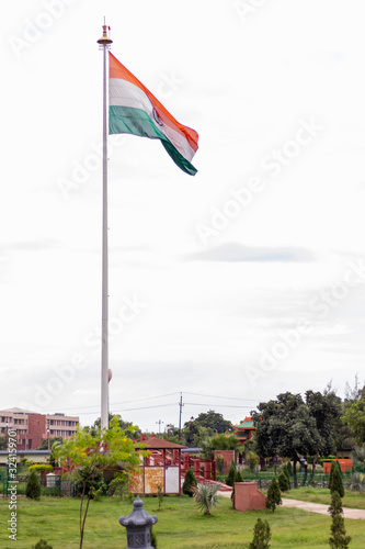 Low angle shot of Indian flag hoisting in a park in India. Patriotism concept