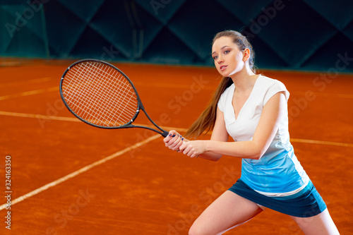 Attractive woman tennis player waiting for service at indoor court © fotofabrika