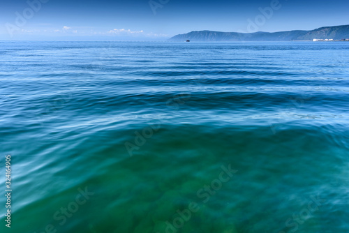Lake Baikal close to village Port Baikal, Russia. Horizontal day view of the high shore and clear lake water