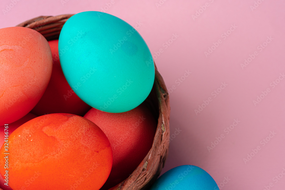 Colored eggs on pink table close up. Object Colored eggs on pink table close up. Object