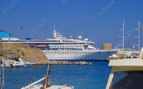 Dream vacation in the Mediterranean on Celestyal Cruises cruiseship or cruise ship liner in summer with blue sky and luxury in Rhodes port photo